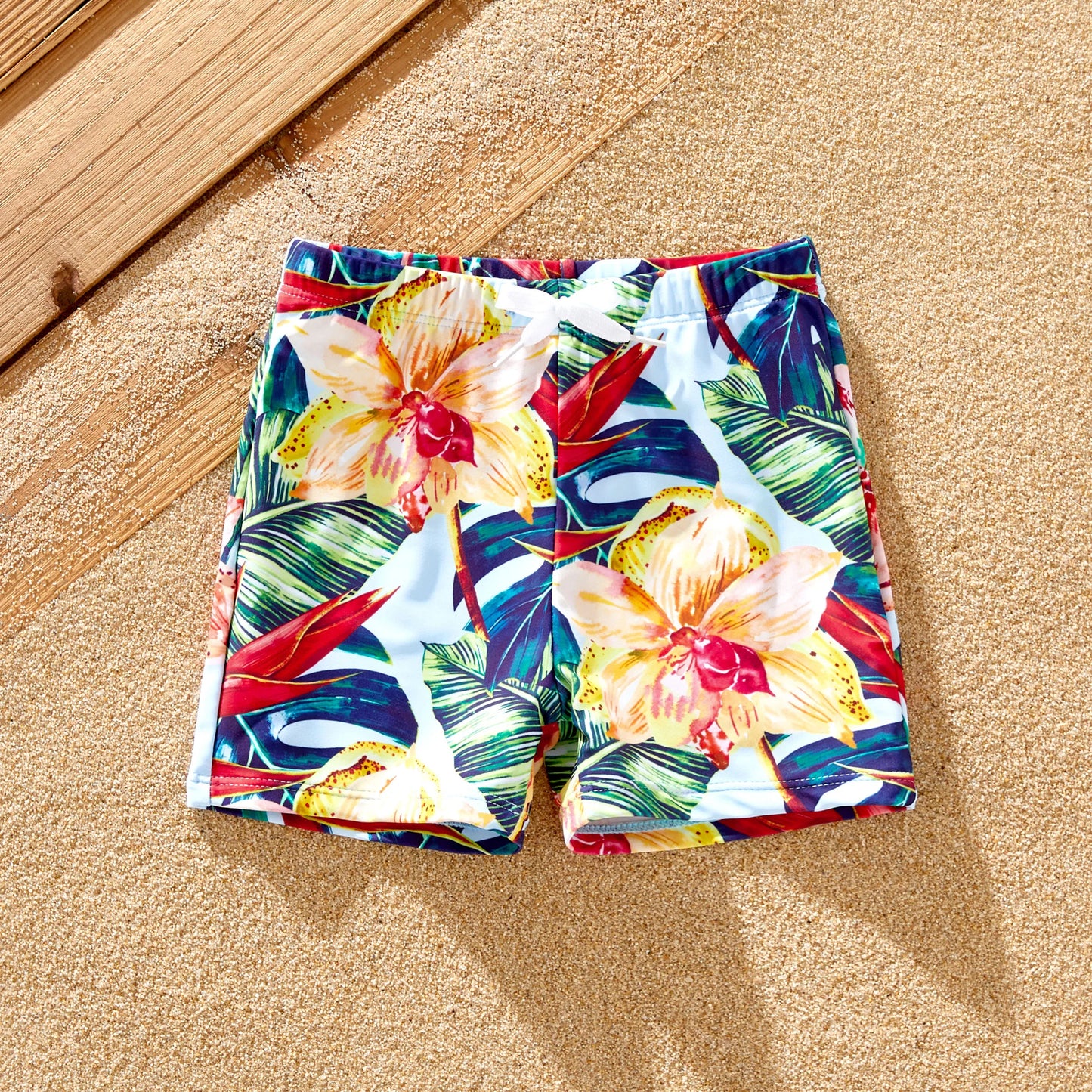 Red floral print one-piece swimsuit for girls, coordinating with family beachwear.