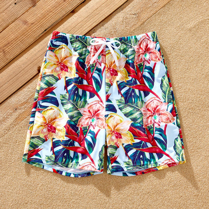 Close-up of red floral print fabric, showing polyester spandex quality of swimwear.