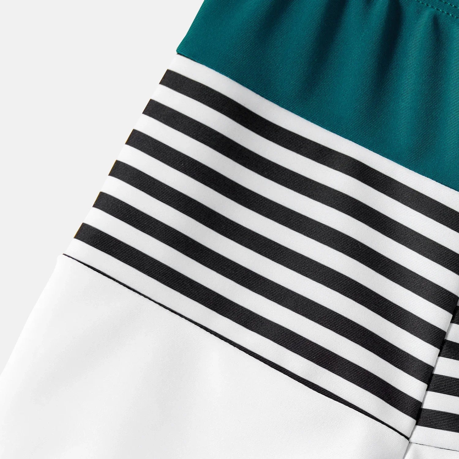 Stylish green one-shoulder bikini top with matching striped swim shorts for family