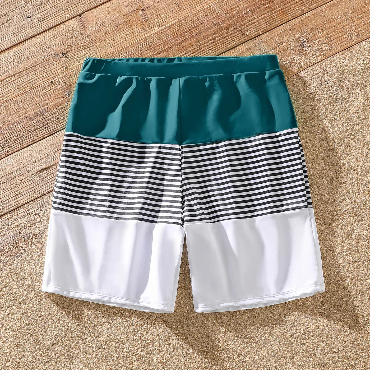 Toddler girl in a green one-shoulder ruffle swimsuit, perfect for poolside fashion