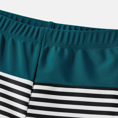 Infant in a cute green one-shoulder swimsuit, part of a family matching set
