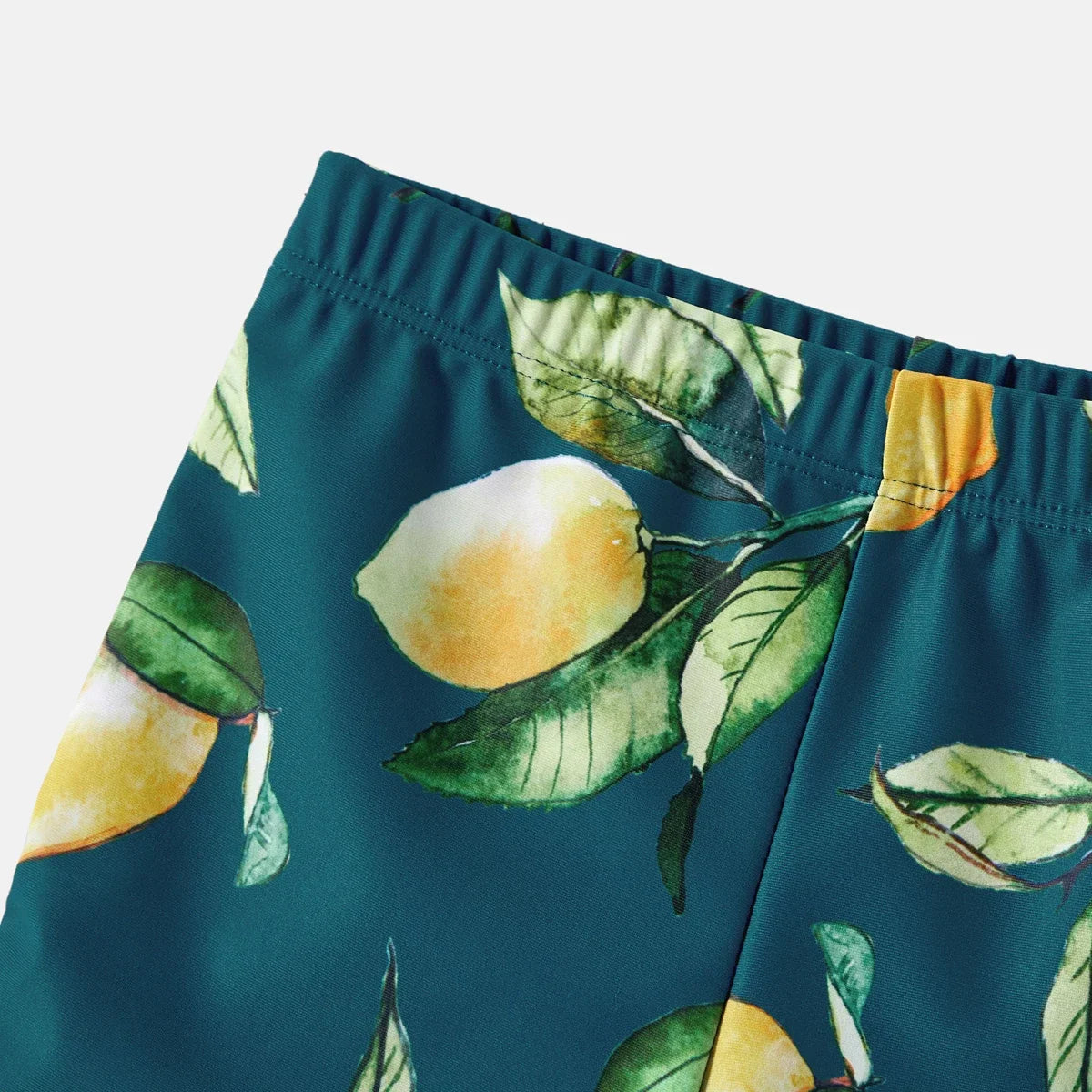 Toddler lemon print rash guard and swim shorts set for sun protection.