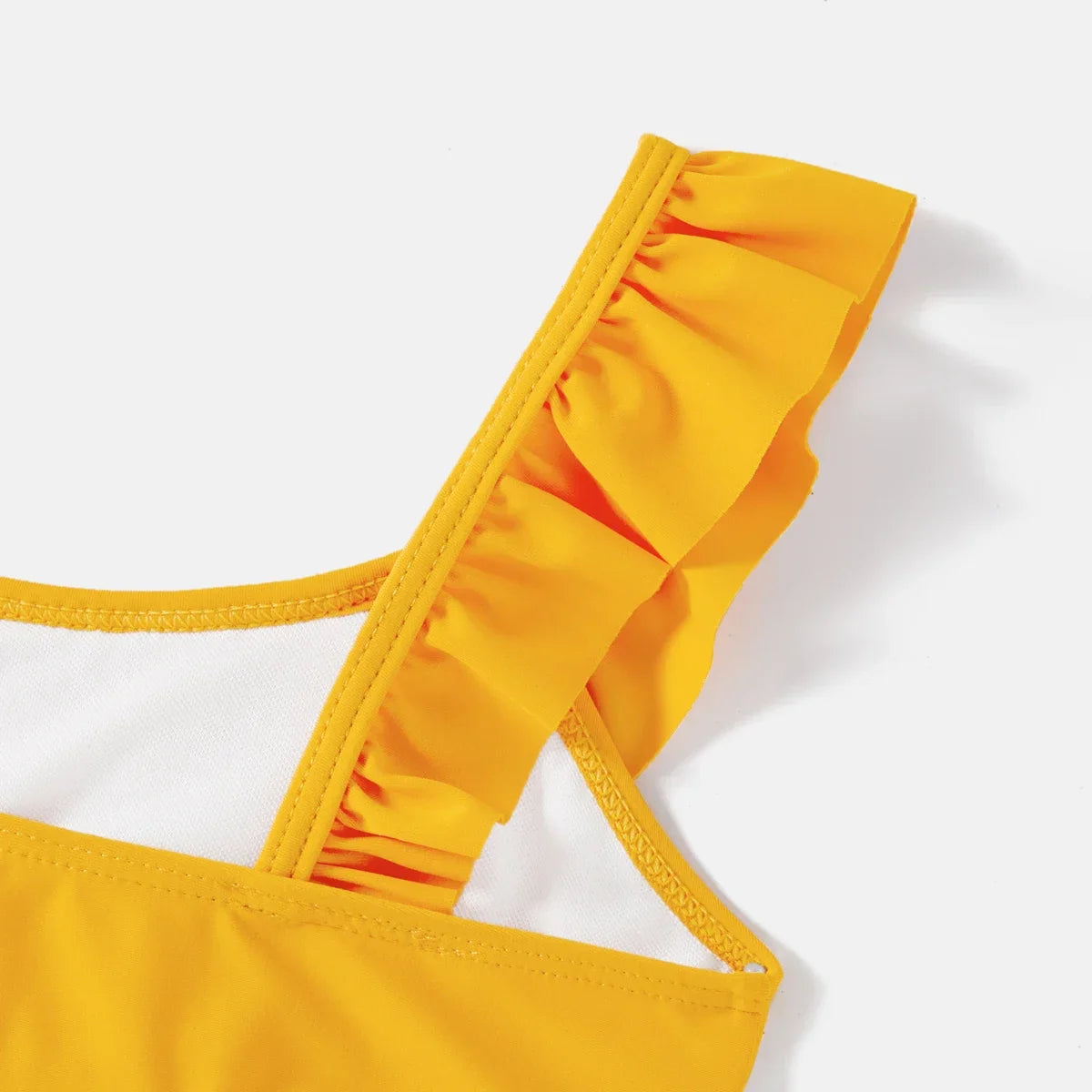 Women's lemon print high-waisted bikini, flattering summer beach wear.