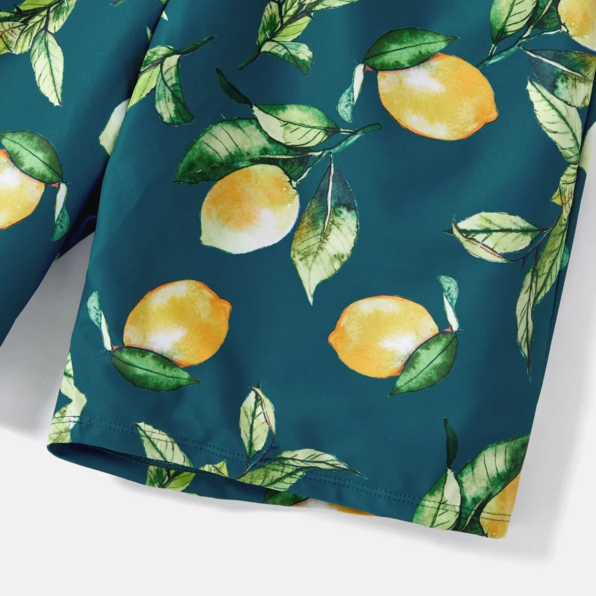 Family matching lemon print swim apparel, ideal for summer vacation and gifting.