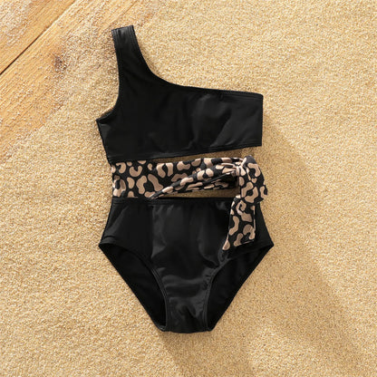 Mother and son in leopard print swimwear set, one-shoulder tie swimsuit and swim trunks