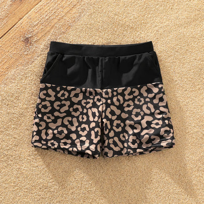 One-shoulder leopard print swimsuit with tie detail and coordinated men's swim trunks