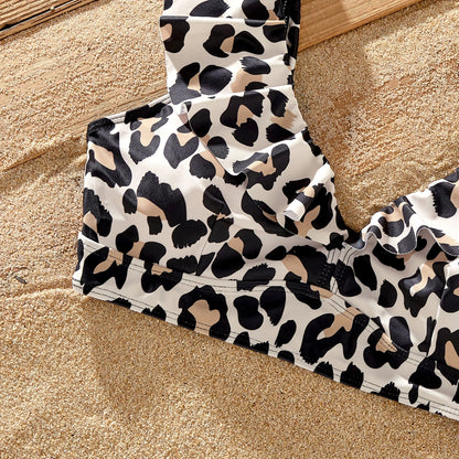 Stylish leopard print women's bikini and men's shorts, part of family matching set