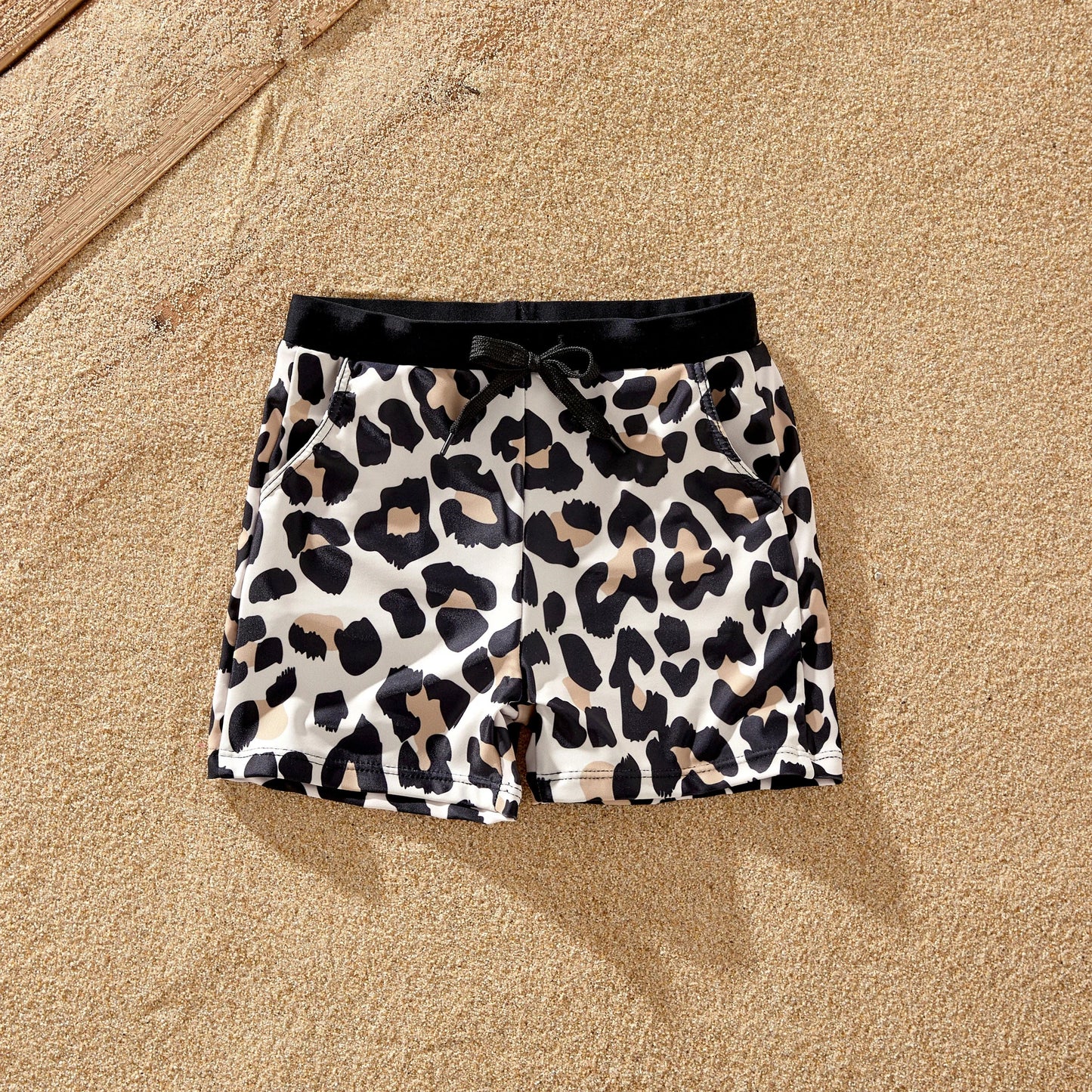 Adorable family matching leopard print bathing suits, ideal for a fun beach day