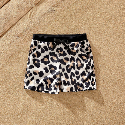 Adorable family matching leopard print bathing suits, ideal for a fun beach day