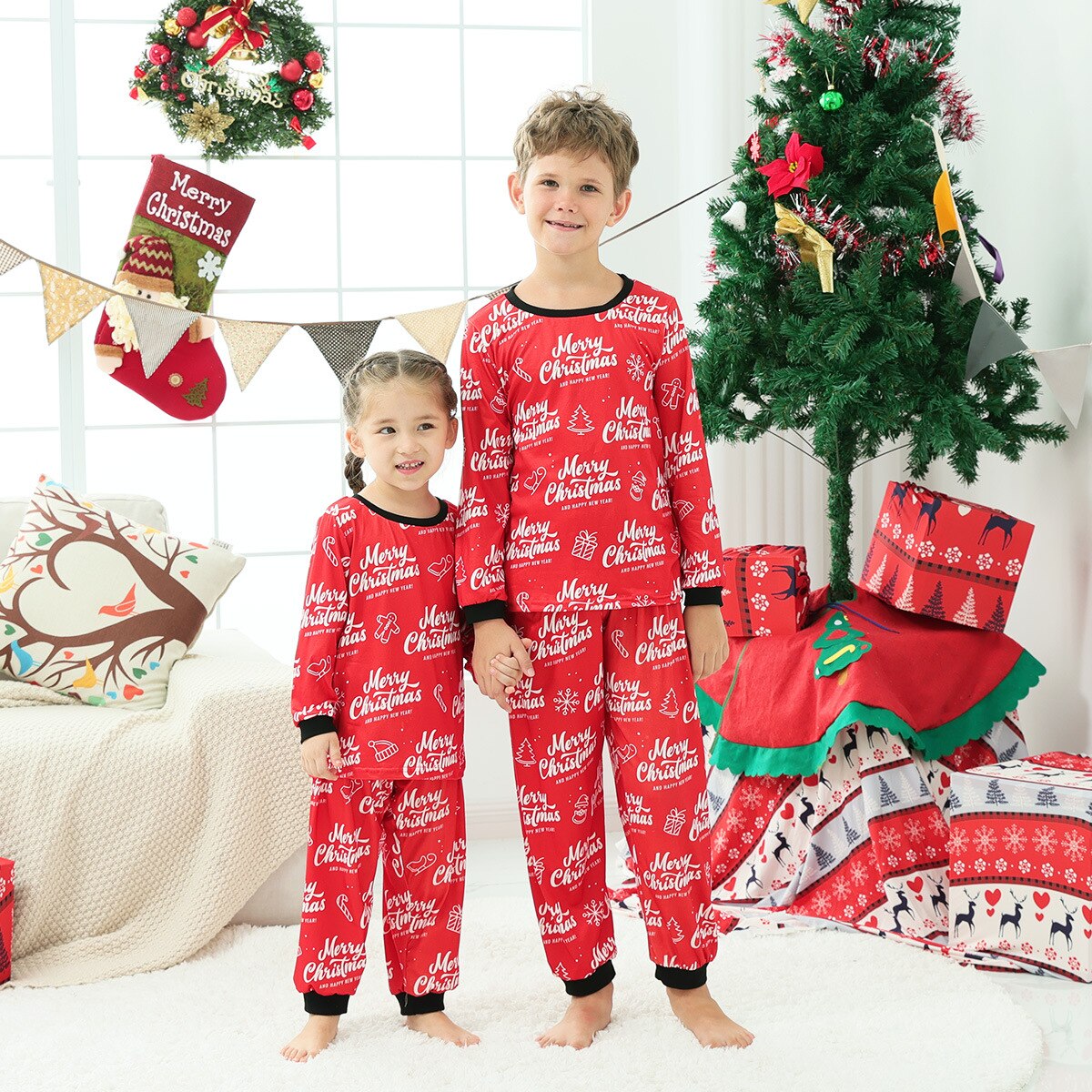 Full family wearing matching long sleeve red and white striped Christmas pajamas, festive holiday apparel