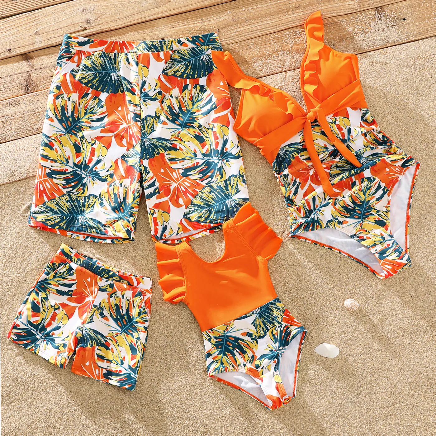 Family matching orange tropical swimwear set for beach holidays.