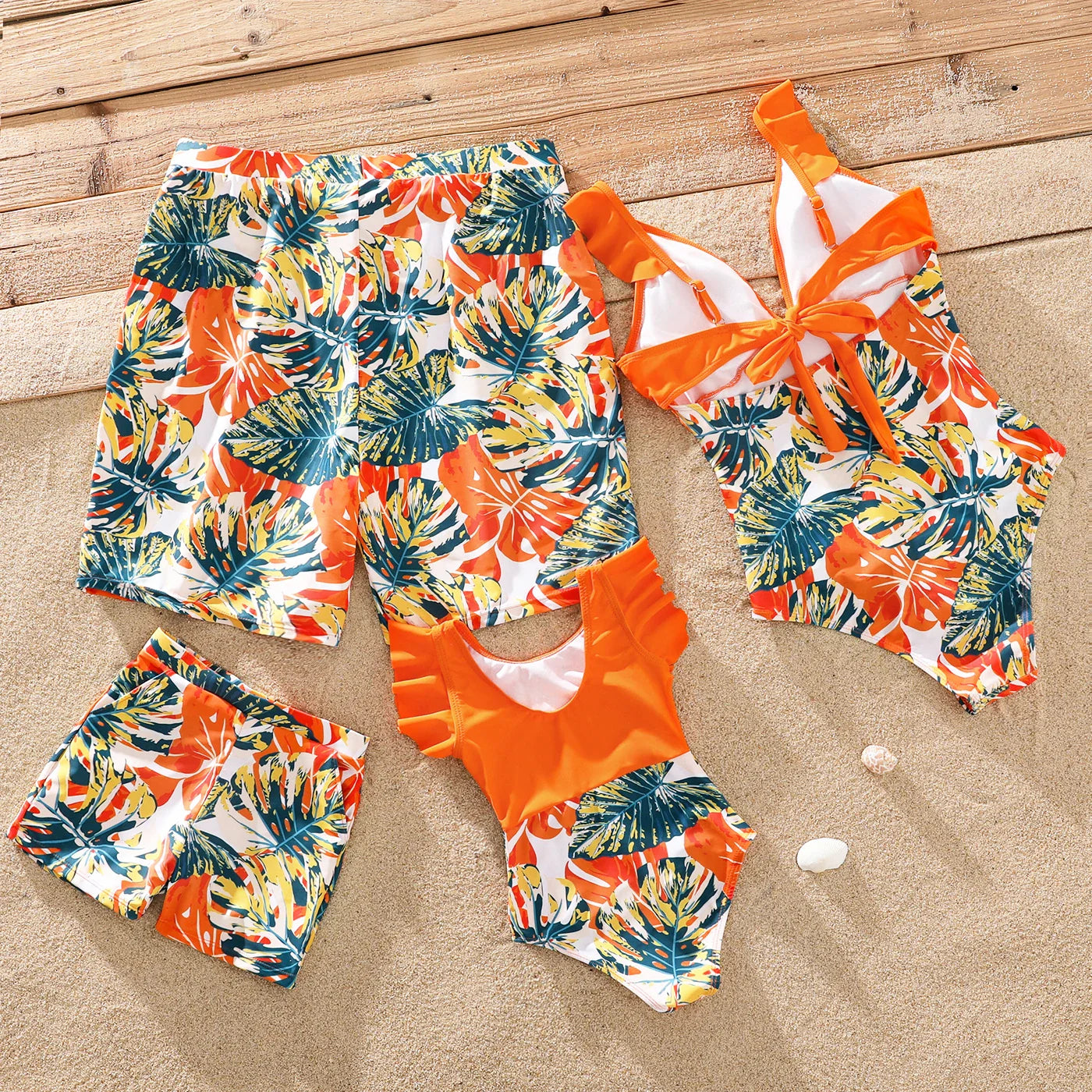 Kids' orange tropical swimwear: matching sets for boys and girls.