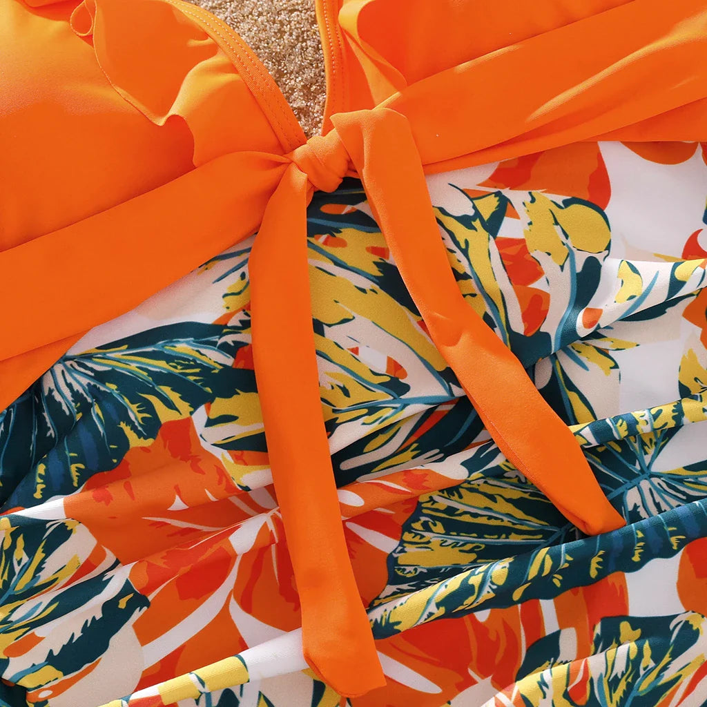 Summer family outfits: orange tropical print swimwear for beach and vacation.