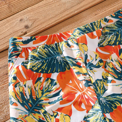 Family beach vacation essentials: orange tropical matching swimwear collection.