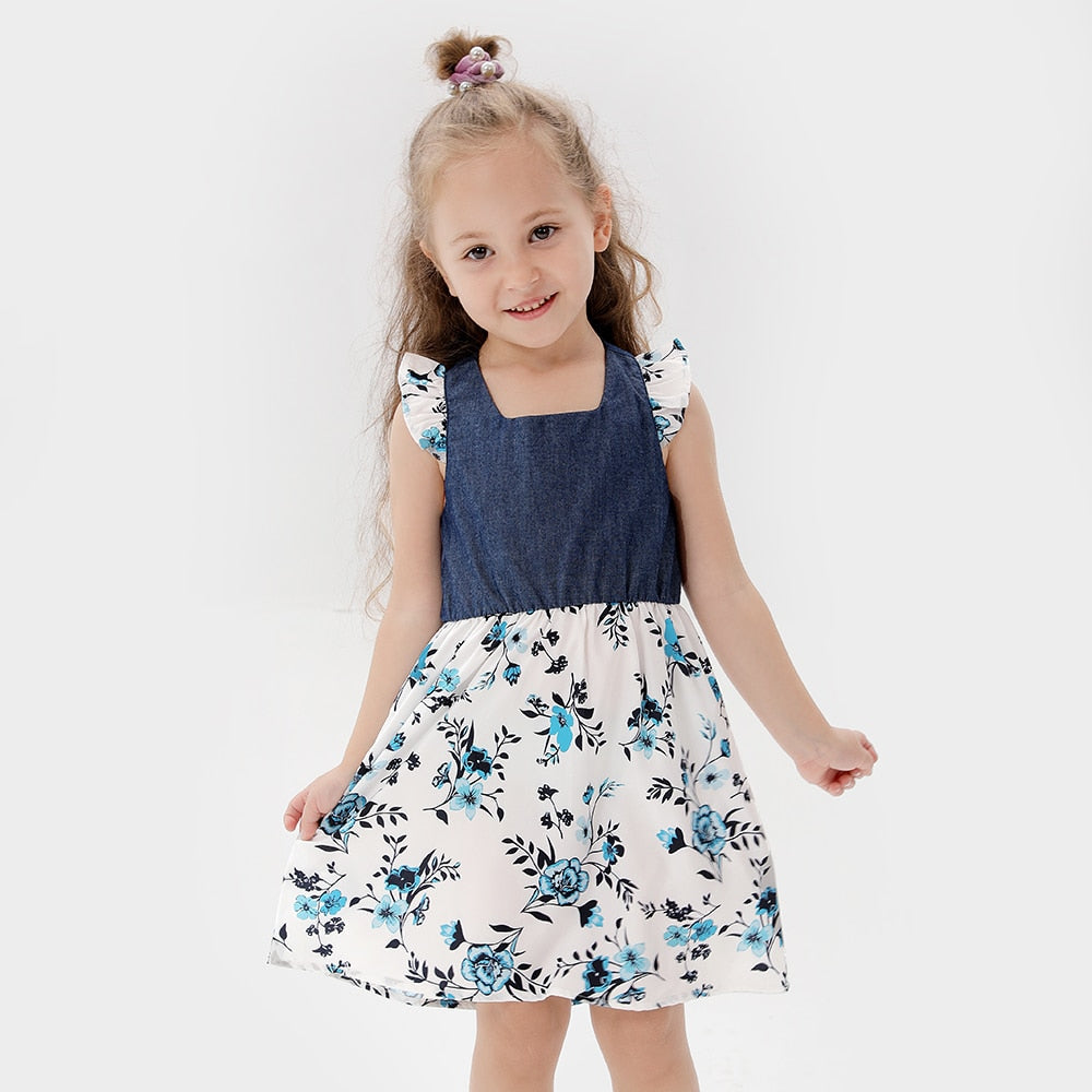 Family photo outfits: happy family in blue chiffon blend coordinated apparel for memorable pictures.