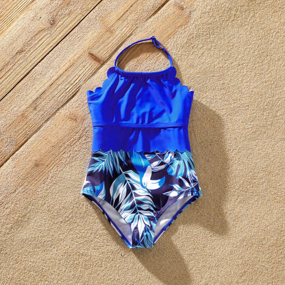 Family in coordinating palm print swimwear, ideal for a vacation getaway