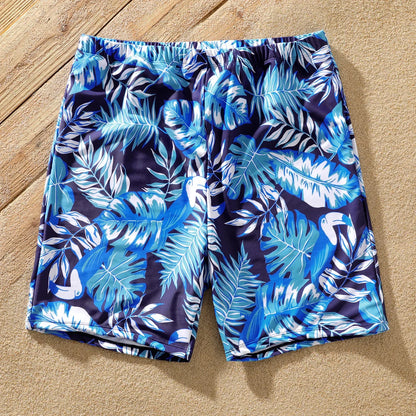 Matching family outfits: swimsuits with green palm leaf design for summer