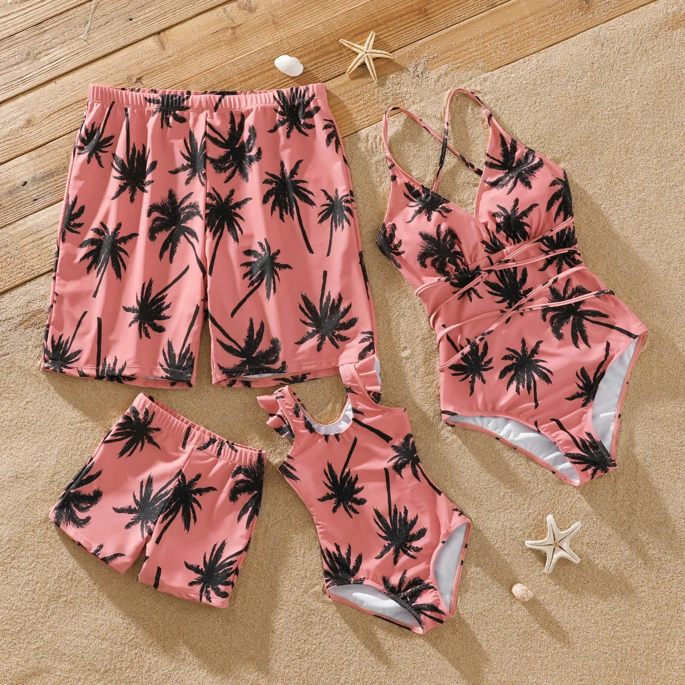 Family matching pink swimsuit set with coconut tree print for beach vacation