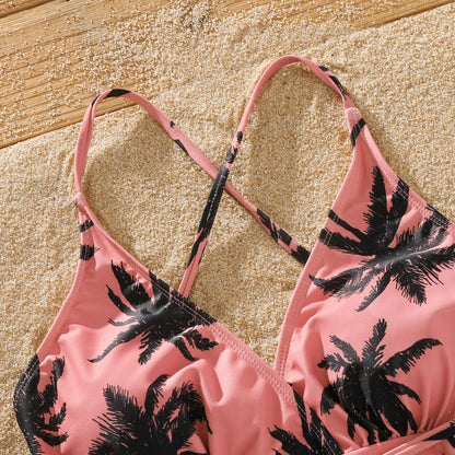 Mom and daughter matching pink bikini with tropical coconut tree pattern