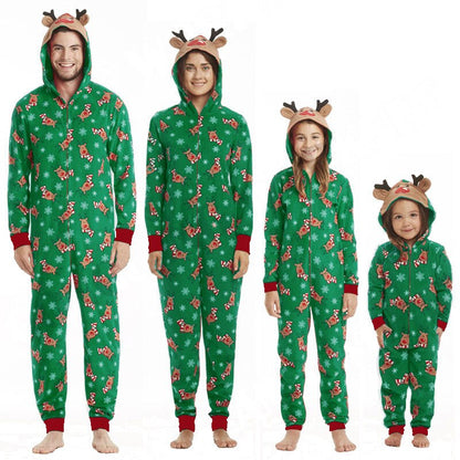 Family relaxing in matching parent-child reindeer jumpsuit pajamas, festive winter cozy sleepwear
