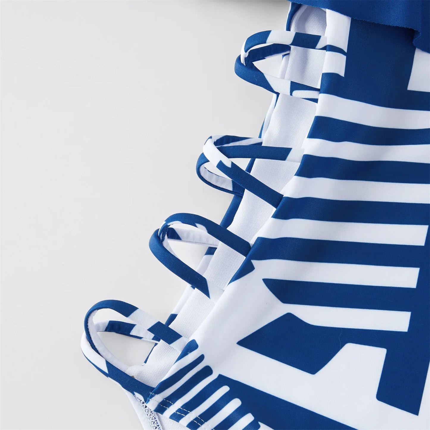 Close-up of a girl's ruffled one-piece swimsuit, ideal for kids' summer swimwear