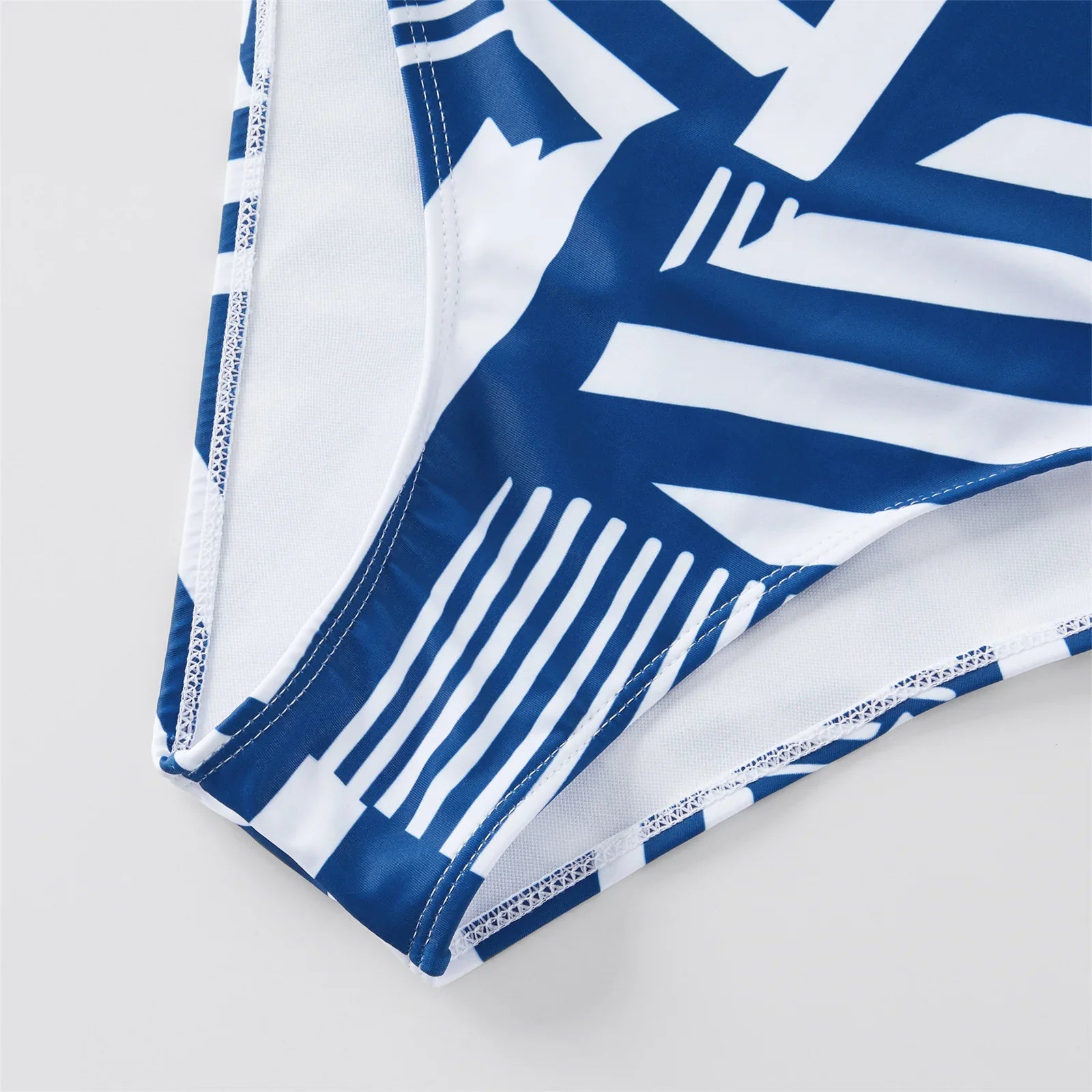 Collection of family matching ruffled one-piece swimsuits and men's swim trunks for holiday wear