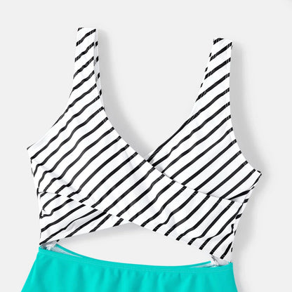 Multigenerational family in striped matching swimwear, enjoying outdoor summer activities