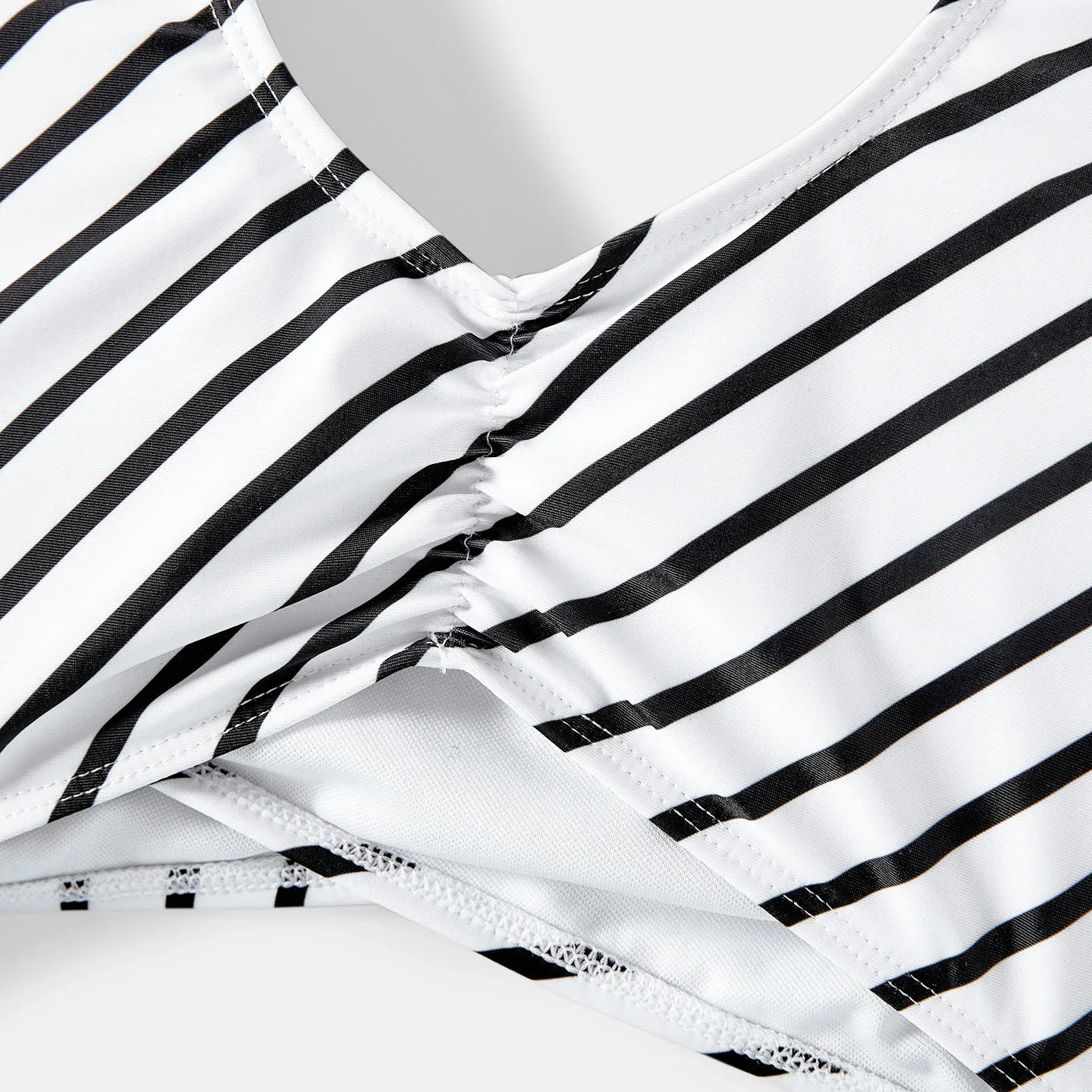 Striped one-piece swimsuit for women and girls, paired with matching striped swim trunks