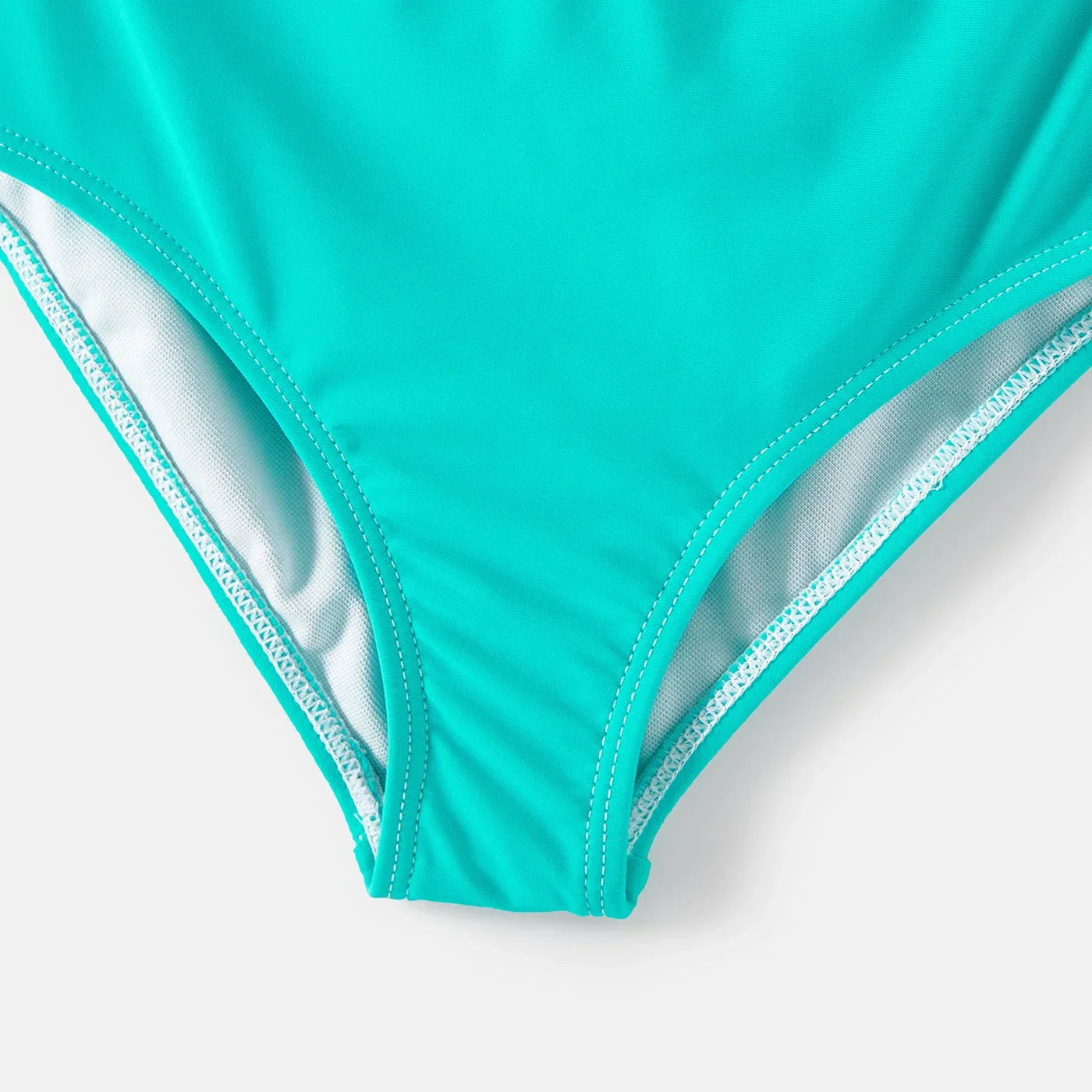 Family ready for the beach in vibrant striped swimwear, a cohesive summer look