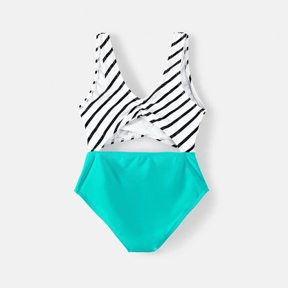 Assortment of striped family matching swimsuits, including one-piece and men's trunks
