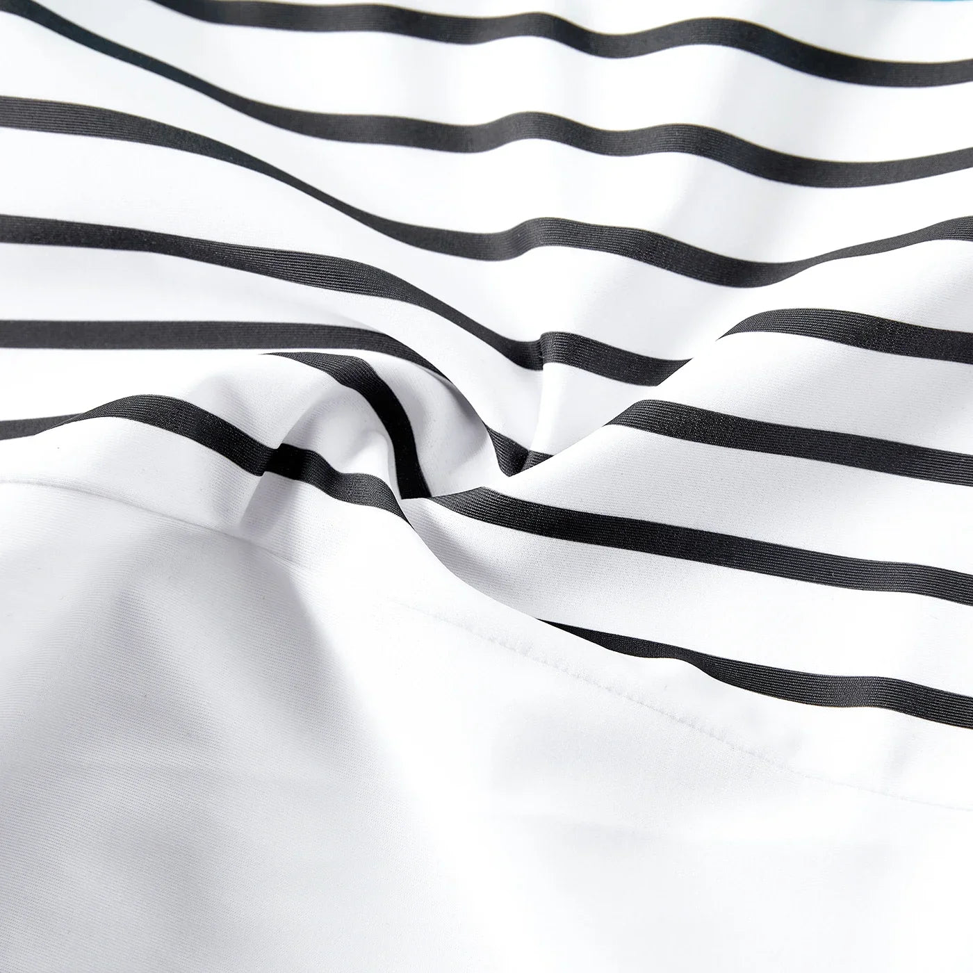 Family modeling striped beach outfits, emphasizing fun and togetherness on holiday