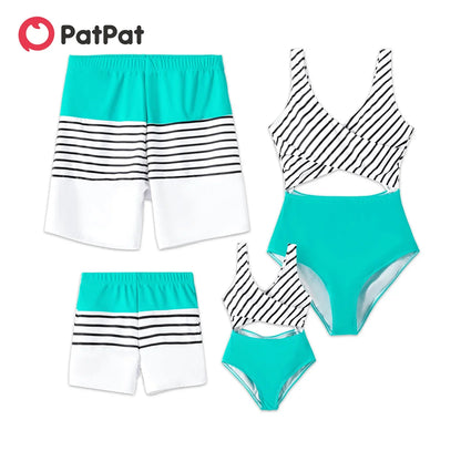 Mom, Dad, and baby in coordinating striped swimwear, ideal for summer poolside fun