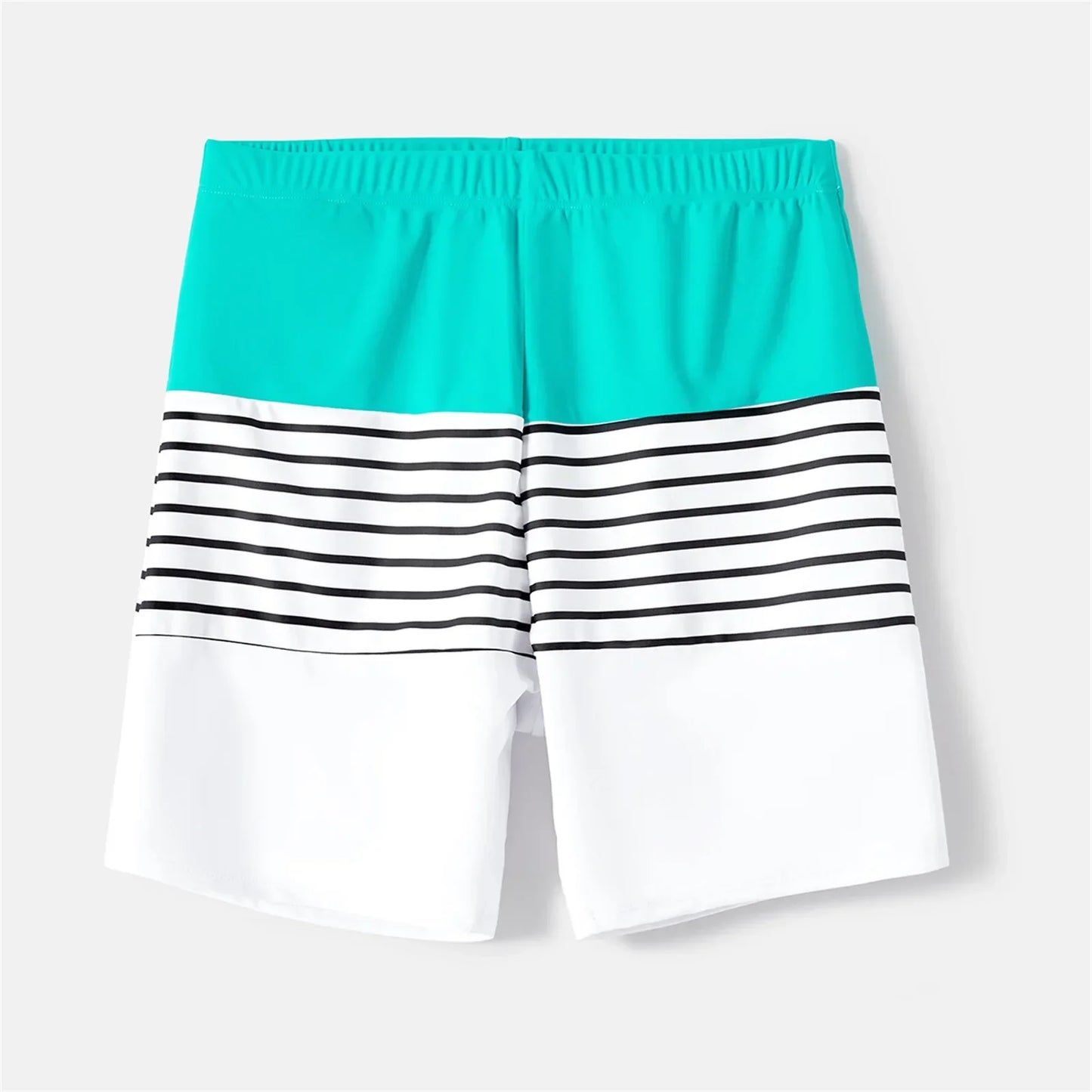 Two adults and a child in matching striped beachwear, vacation essentials for families