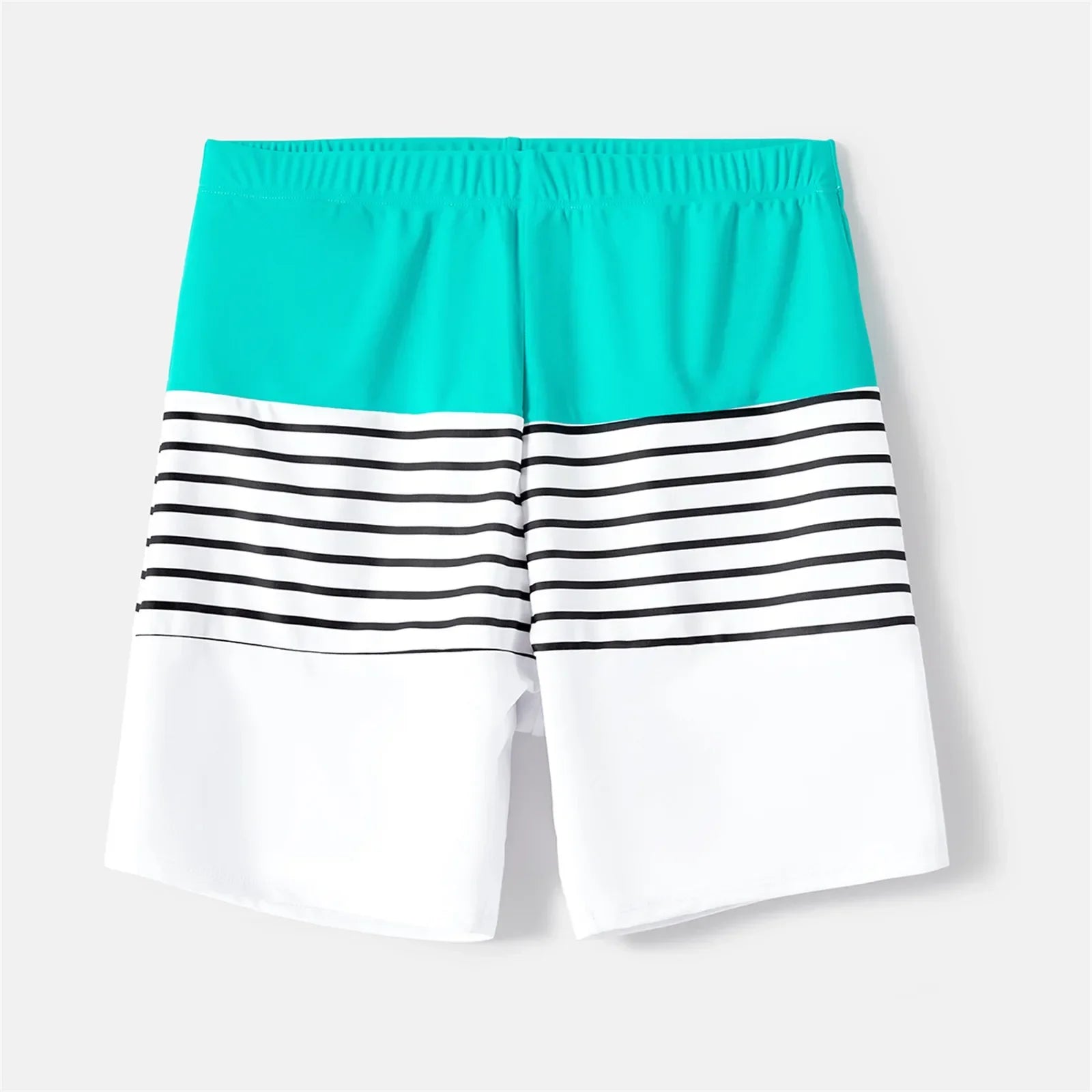 Two adults and a child in matching striped beachwear, vacation essentials for families