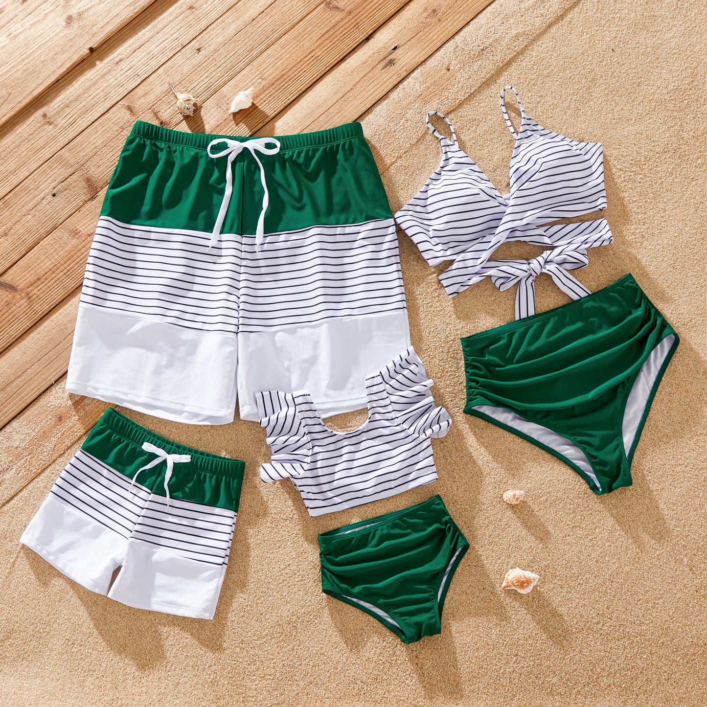 Family matching striped swimsuits in green for summer vacation fun by the beach
