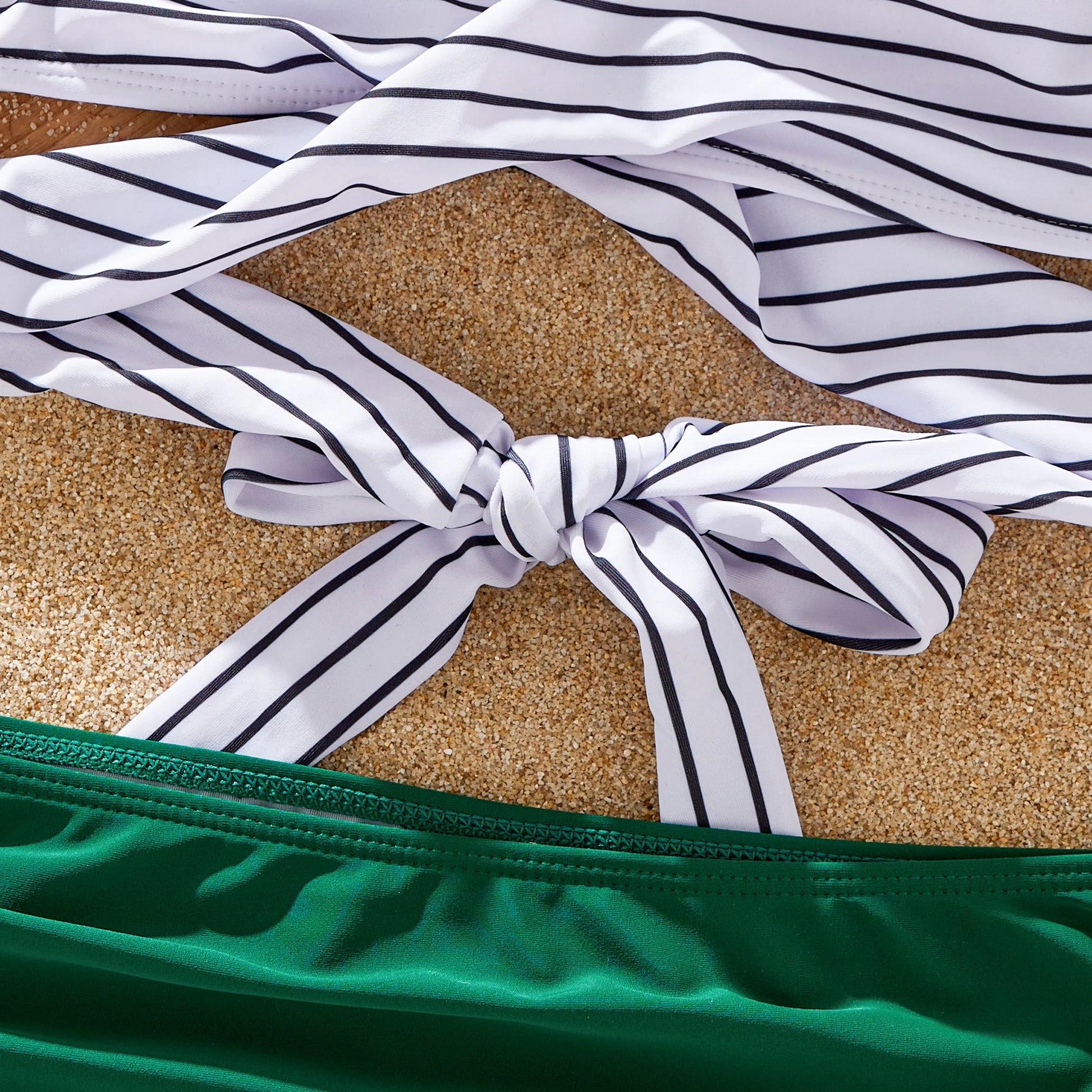 Green striped tankini for women, offering comfort and style for family summer fun