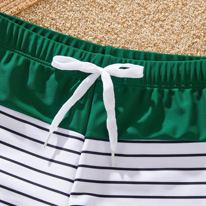Close-up of green and white striped pattern on family matching beachwear fabric
