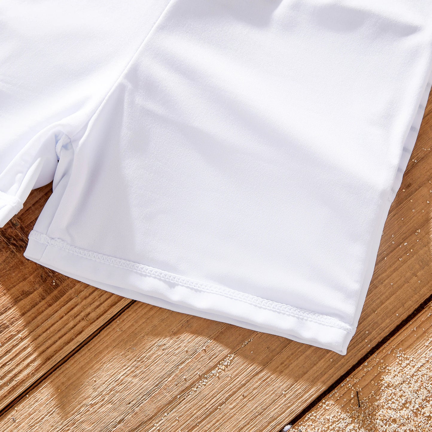 Dad's green striped swim trunks, part of a family matching swimwear set