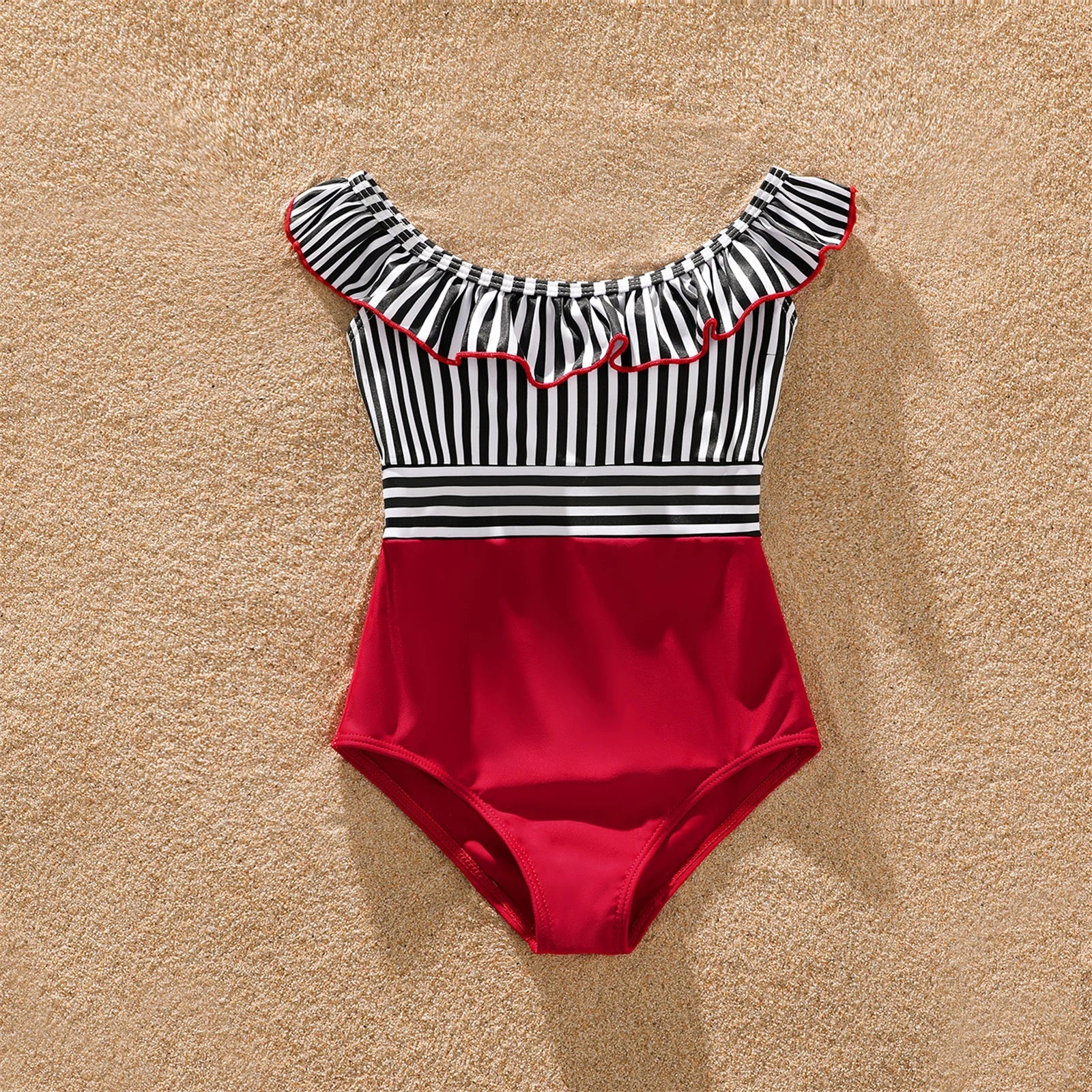 Mom, dad, and child wearing coordinating striped swimsuits, perfect family beachwear.