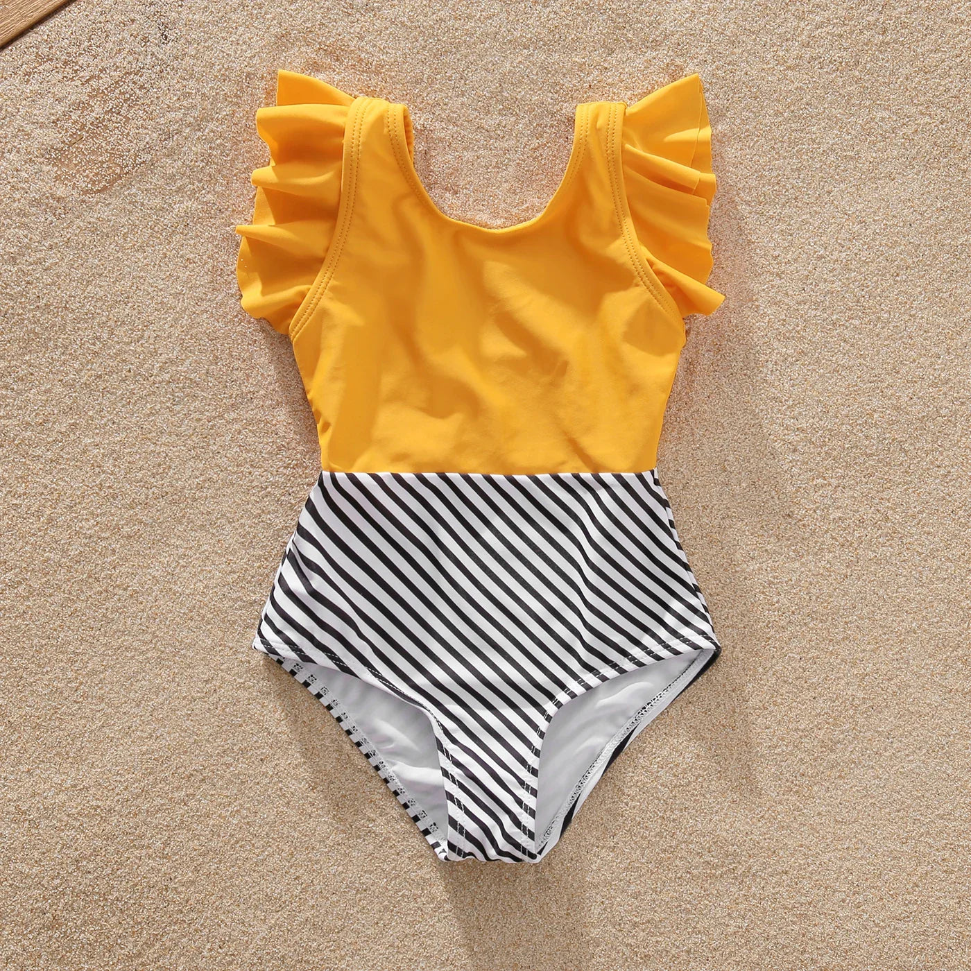 Close-up of striped fabric on family matching swimwear, quality beachwear material