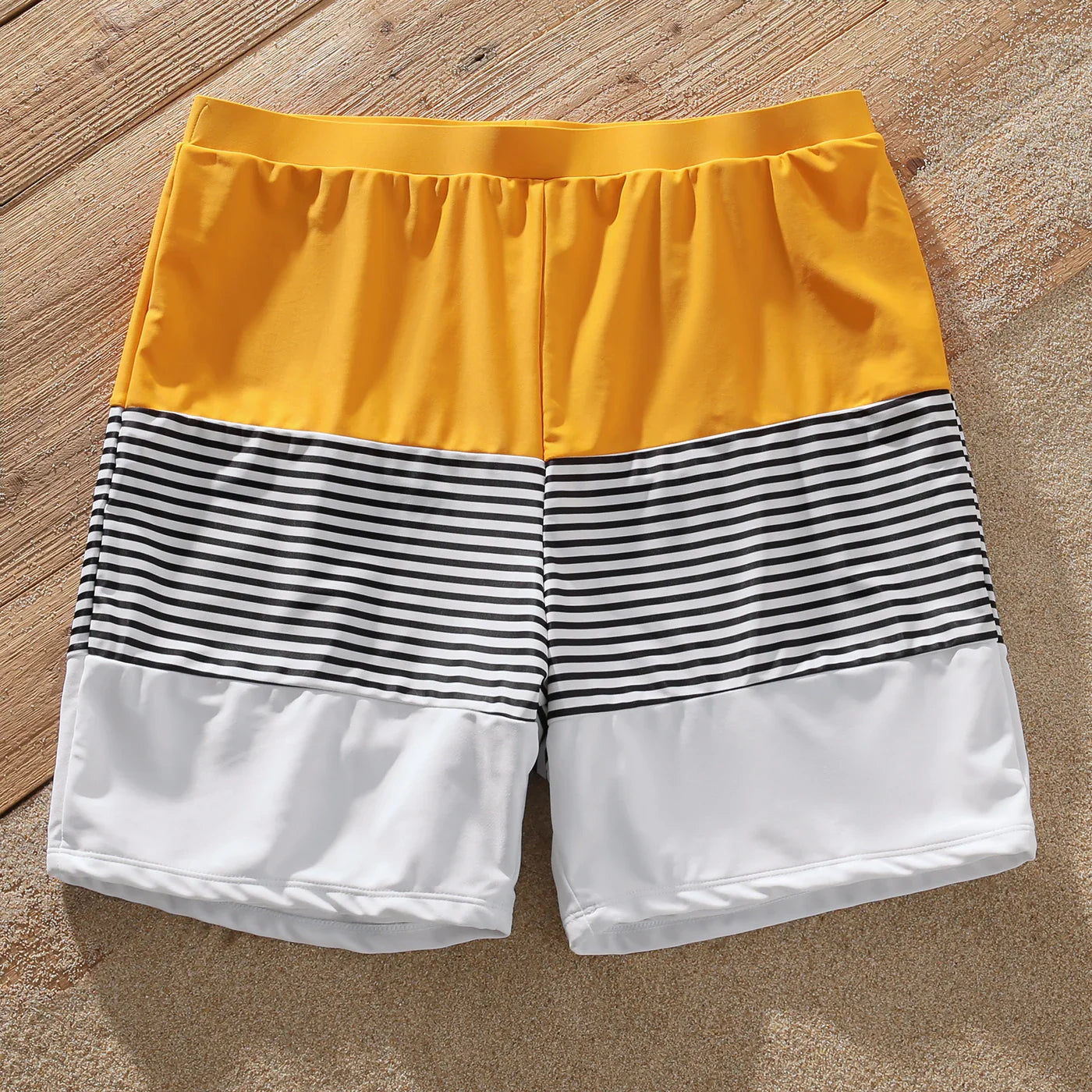 Coordinated striped family beachwear, children's playful swimsuits, adult stylish swimwear
