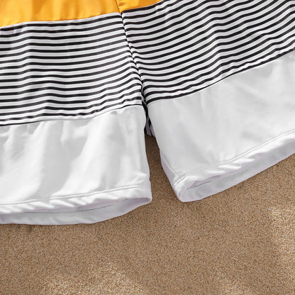 Diverse family in coordinating yellow striped swimwear set, summer