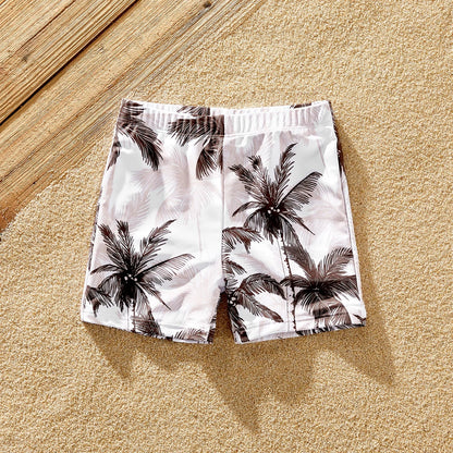 Family matching swimwear collection with vibrant coconut tree print, ideal for a tropical holiday