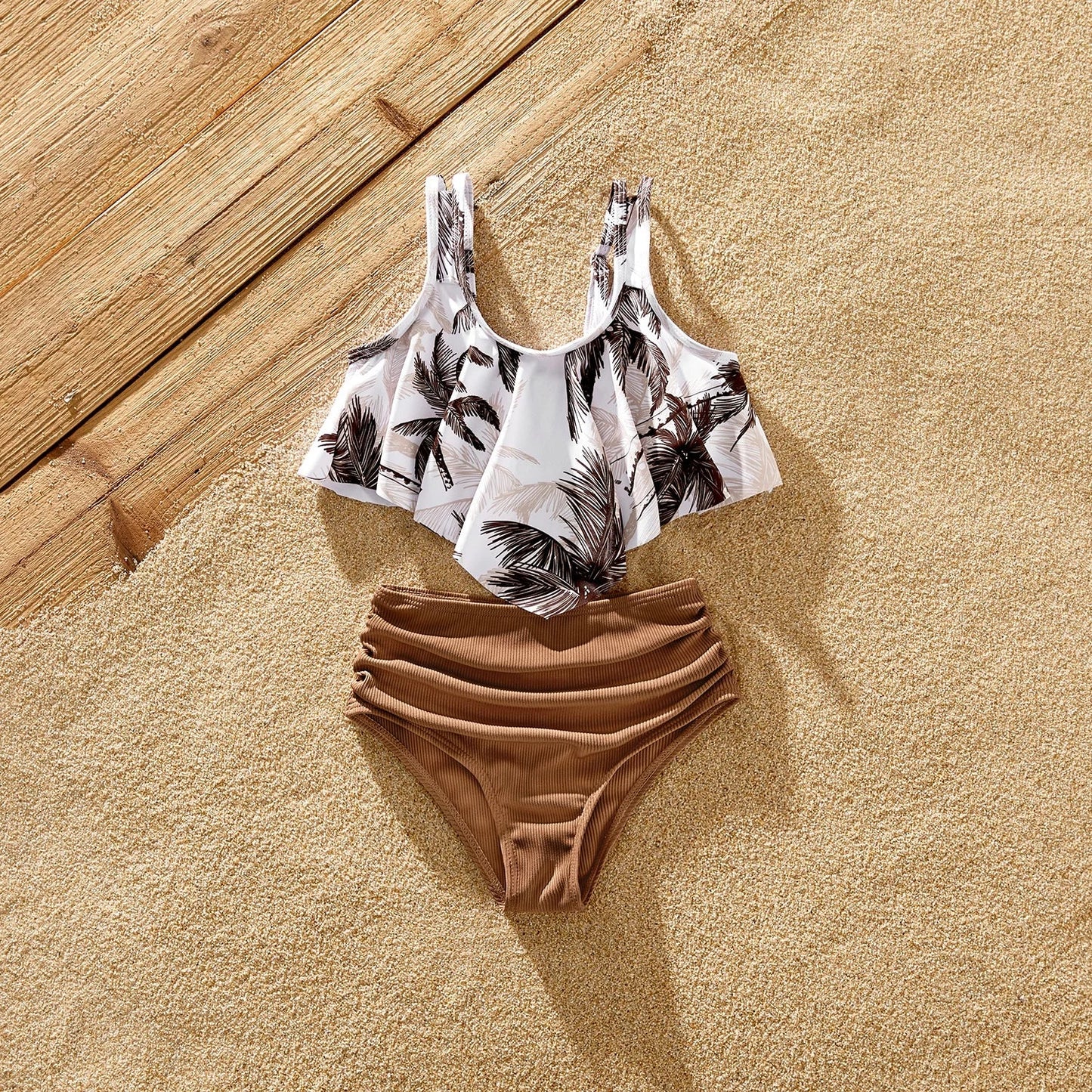 Assortment of family matching swimsuits with coconut tree graphics for a fun beach outing