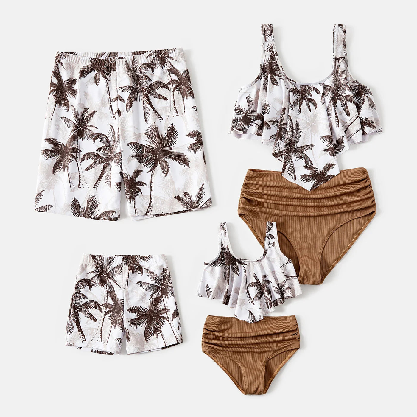 Family posing on a sandy beach wearing matching coconut print vacation swimsuits; summer fashion