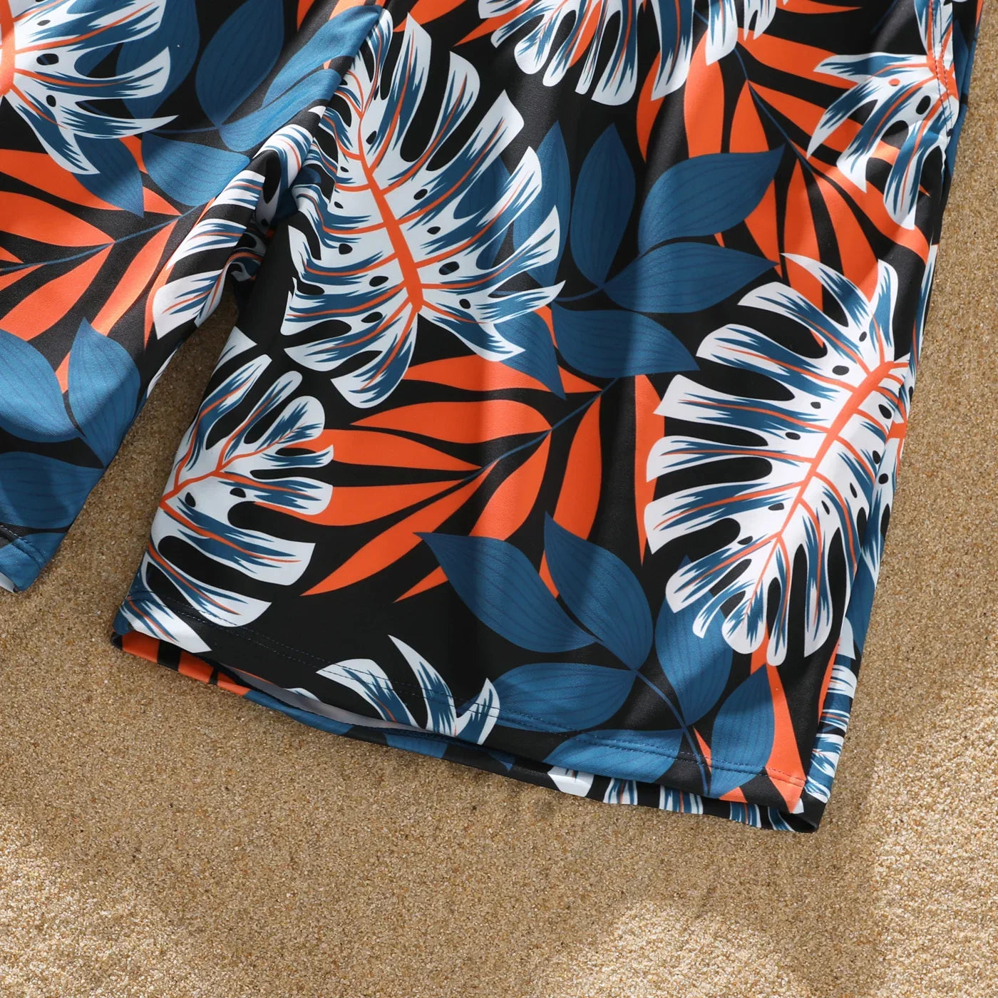 Detail shot of the comfortable polyester spandex fabric of palm leaf family swimwear