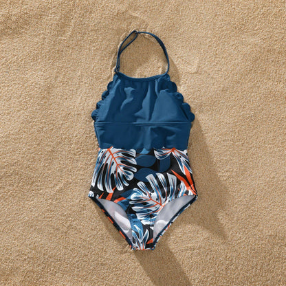 Father and son matching palm leaf swim shorts for a comfortable beach vacation