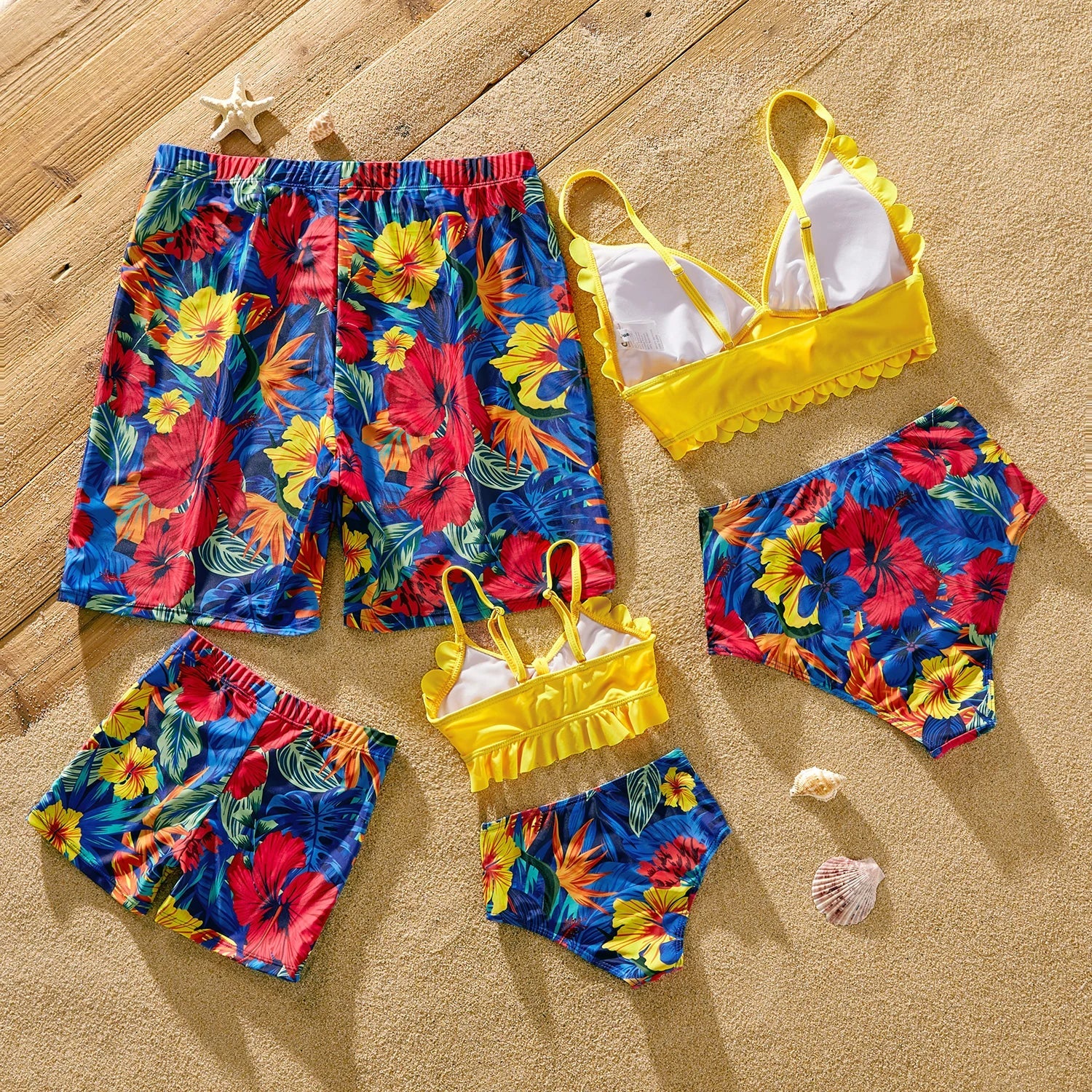 Stylish scallop trim swimsuit alongside floral print swim trunks for a cohesive family look.