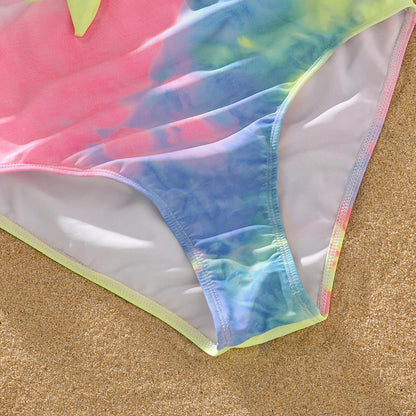 Detailed view of the V-neckline and tie-dye print on a women's swimsuit