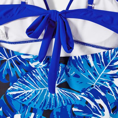 Kids' tropical leaf print swimsuit, one-piece with ruffles, vibrant and playful beachwear.